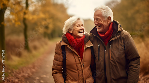 elderly senior couple walking together in autumnal forest. retirement enjoying