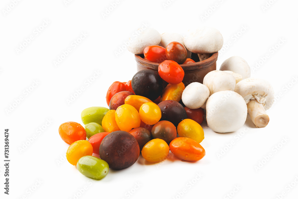 Colorful tomatoes and mushrooms isolated on white background. Top view. Colorful tomatoes and mushrooms isolated on white background. Top view.