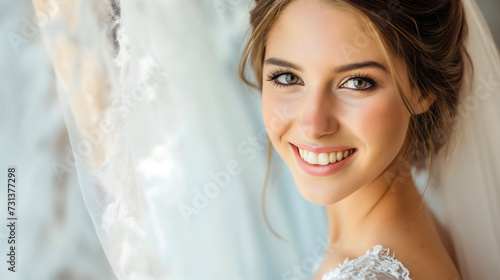 Closeup portrait of a beautiful young bride, youthful woman or lady wearing a white wedding dress, looking at the camera and smiling. Female marriage person elegance, happy Caucasian model in love