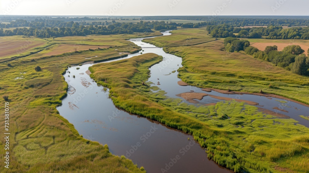 Winding river through vibrant green landscape from a bird's-eye view at sunset Winding river through vibrant green landscape from a bird's-eye view at sunset