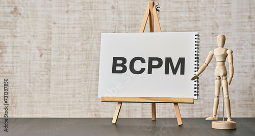There is notebook with the word BCPM. It is an abbreviation for Business Continuity Plan Management as eye-catching image. photo