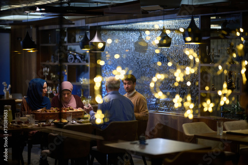 A modern and traditional European Islamic family comes together for iftar in a contemporary restaurant during the Ramadan fasting period, embodying cultural harmony and familial unity amidst a