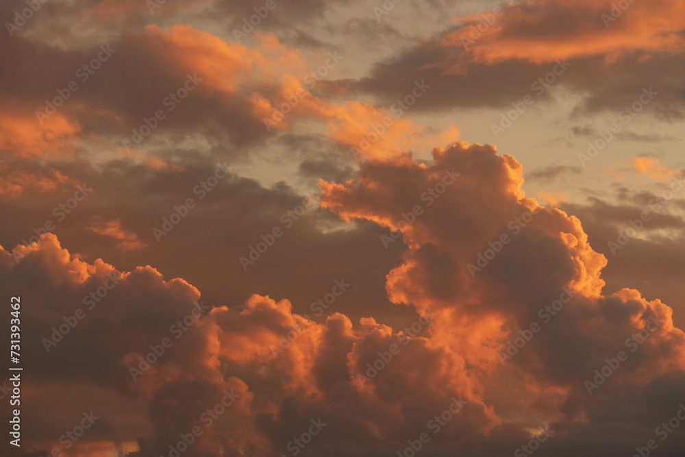 Fototapeta premium Orange Sunset background with different textures and colors in the clouds.