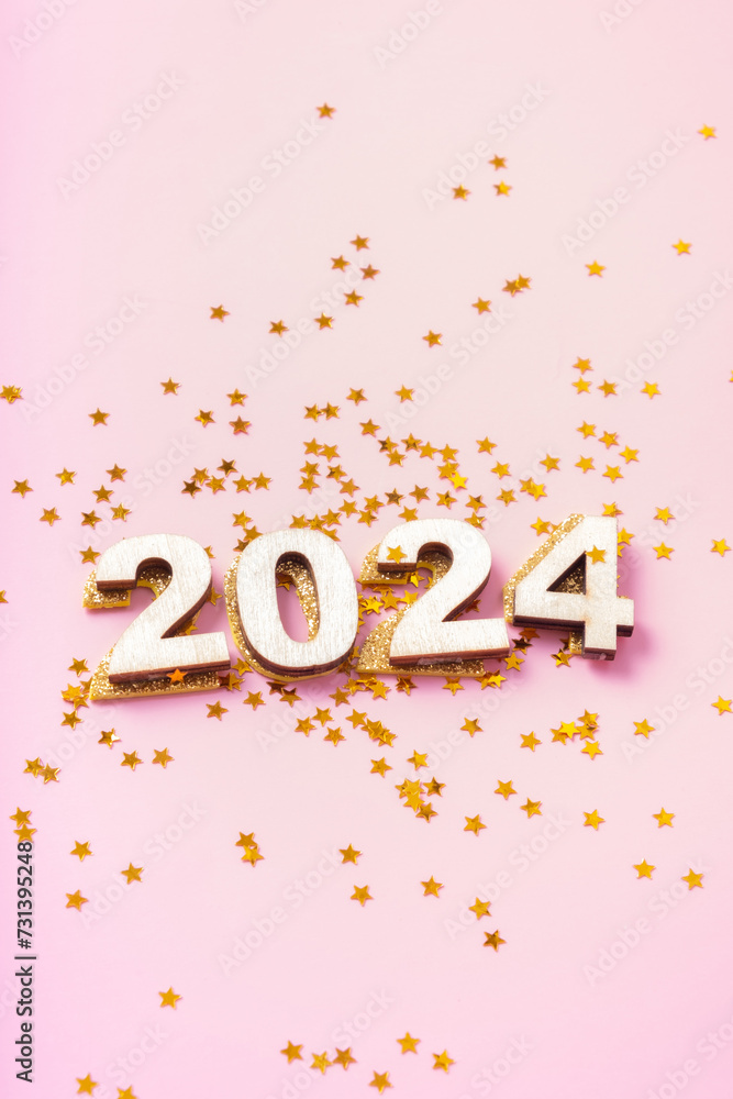 Numbers 2024 and stars on a pink background. Happy new year concept