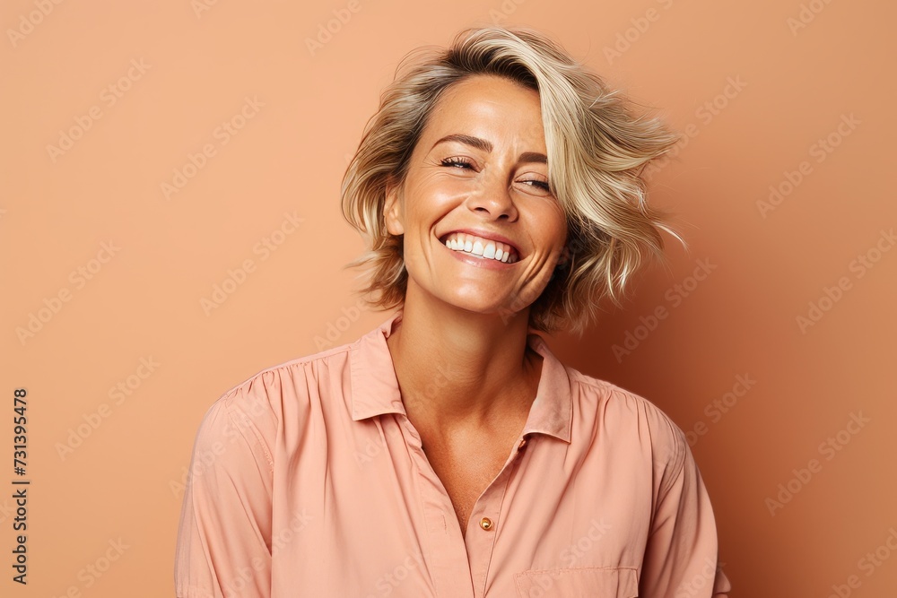 Portrait of a happy middle-aged woman smiling against brown background Portrait of a happy middle-aged woman smiling against brown background