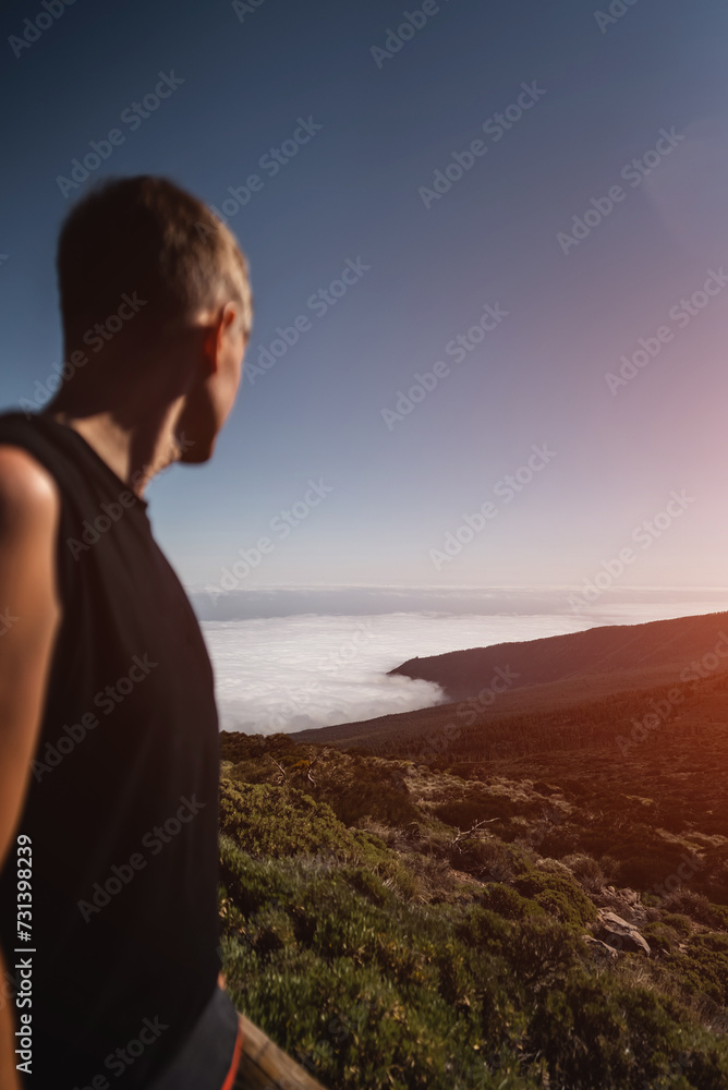 man at high mountain and green forest over clouds, cloudscape, Tenerife, Canary man at high mountain and green forest over clouds, cloudscape, Tenerife, Canary