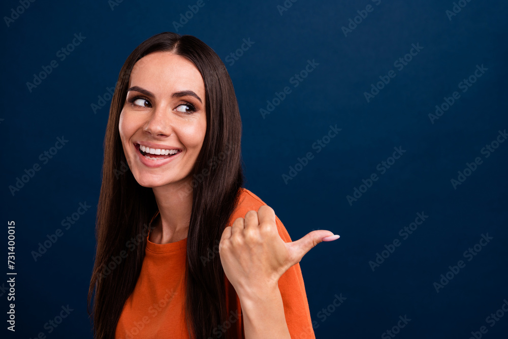 Portrait of adorable person with long hair wear stylish clothes look directing at sale empty space isolated on dark blue background Portrait of adorable person with long hair wear stylish clothes look directing at sale empty space isolated on dark blue background