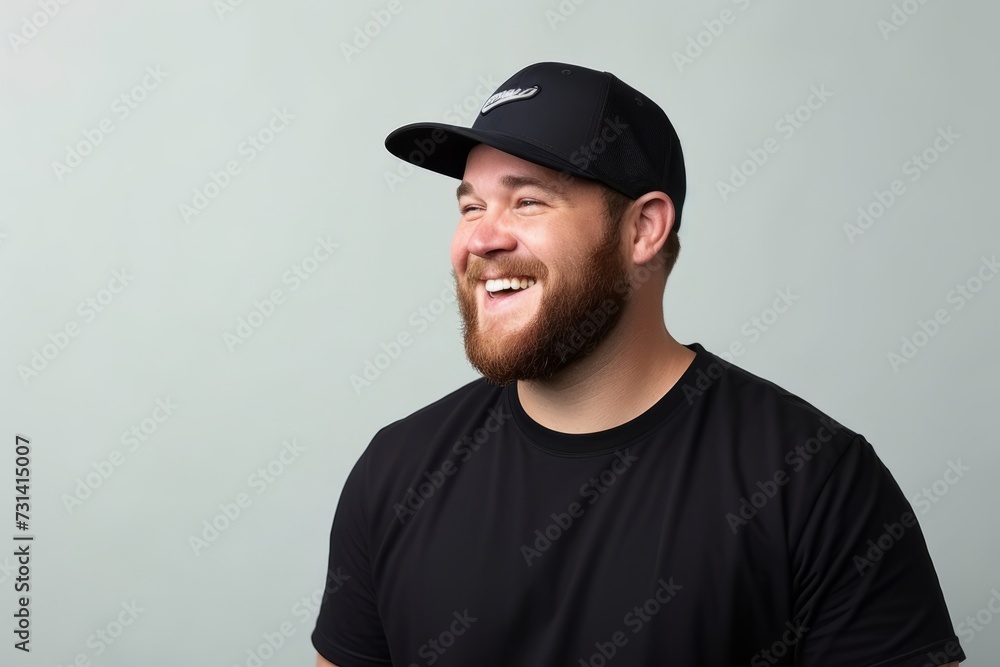 Portrait of a happy bearded man in black t-shirt and cap Portrait of a happy bearded man in black t-shirt and cap
