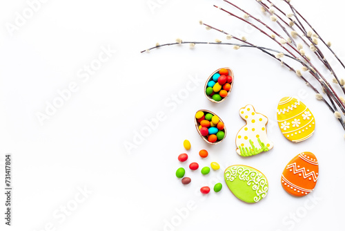 Happy Easter background with eggs and bunny cookies with spring branch, top view © 9dreamstudio