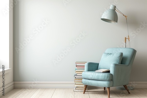 Cozy reading nook with a pastel blue armchair and a stack of books beside a floor lamp. Place for text photo
