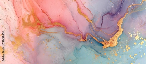 Pastel colors blend with gold powder, forming a marbled surface in abstract trend art, resembling liquid marble texture on paper.