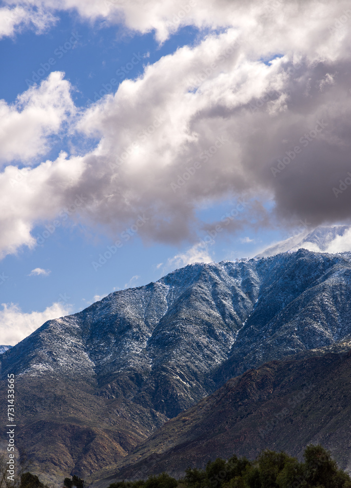 clouds over a snowy mountain clouds over a snowy mountain