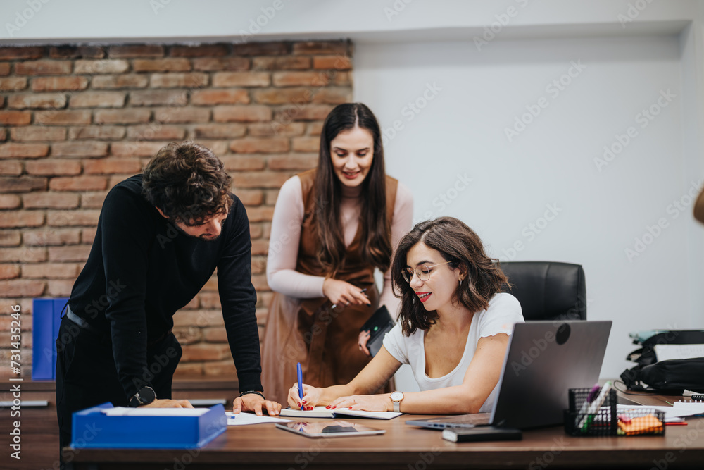 Team of three professionals collaborating in a modern office, focused on paperwork and planning strategies. Team of three professionals collaborating in a modern office, focused on paperwork and planning strategies.