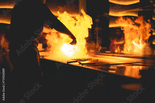 Fotografija Teppanyaki is a post-World War II style of Japanese cuisine that uses an iron griddle to cook food