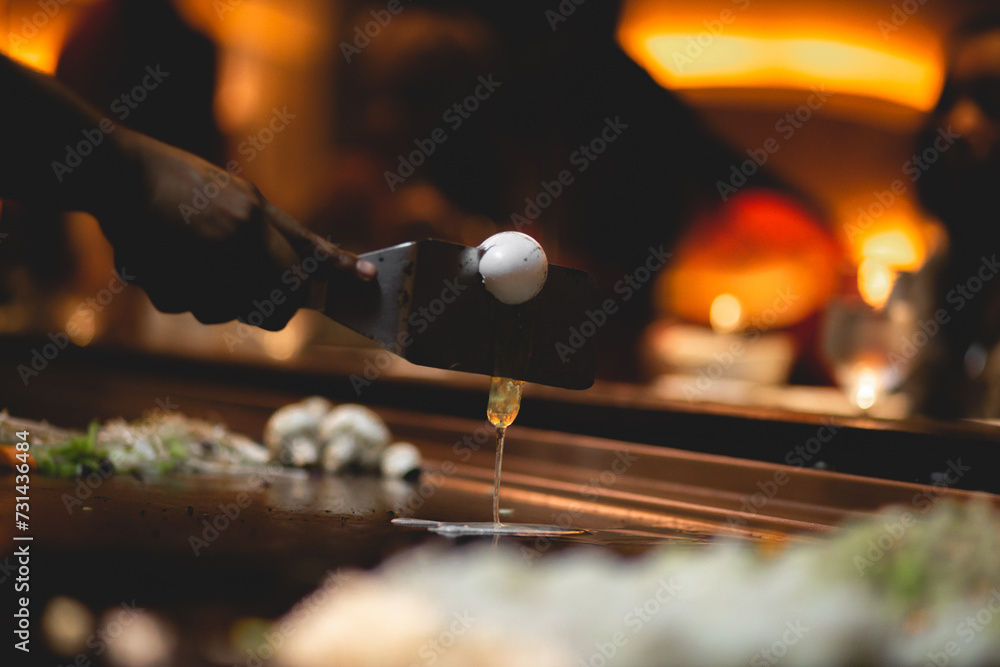 In Teppanyaki, Japanese cuisine style,c hef might juggle utensils, flip a shrimp tail into their shirt pocket, catch an egg in their hat, toss an egg up in the air and split it with a spatula In Teppanyaki, Japanese cuisine style,c hef might juggle utensils, flip a shrimp tail into their shirt pocket, catch an egg in their hat, toss an egg up in the air and split it with a spatula