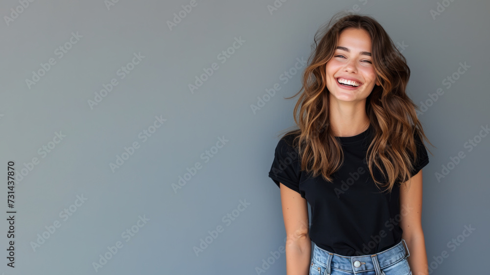 Brunette young woman wear black t-shirt smile isolated on grey background