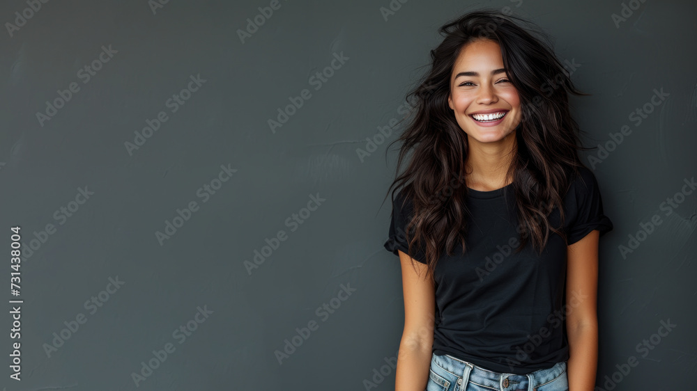 Hispanic young woman wear black t-shirt smile isolated on grey background Hispanic young woman wear black t-shirt smile isolated on grey background