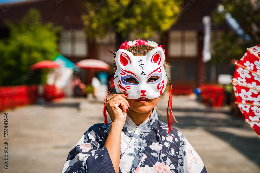 Asian girl in kimono and umbrella in Japanese theme park Hinoki Land in Chai Prakan District, Chiang Mai, Thailand
