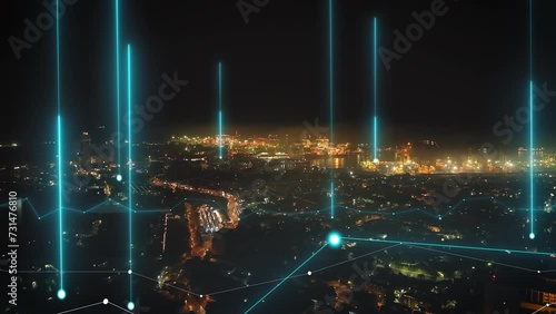 Forwards fly above night city. Aerial view of urban borough and logistic terminal in seaport glowing into dark. Colombo, Sri Lanka. Added augmented reality visual effects photo