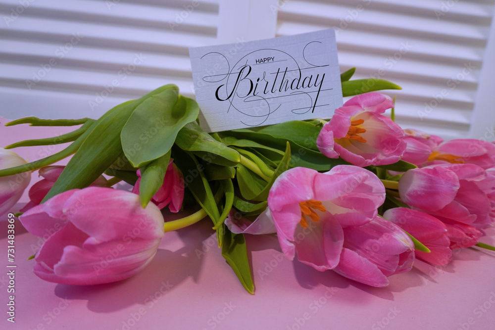 Fototapeta premium postcard , Internet banner with a birthday greeting, with the inscription - happy birthday, a bouquet of flowers with a note of congratulations