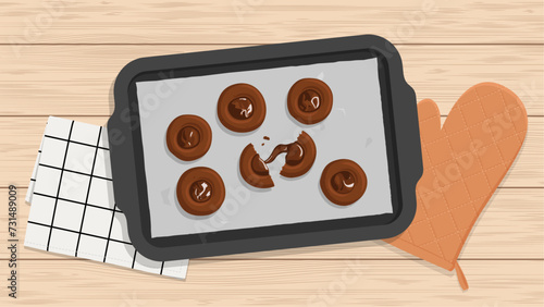 Top view of. thumbprint chocolate cookies on baking pan on wooden table   (ID: 731489009)