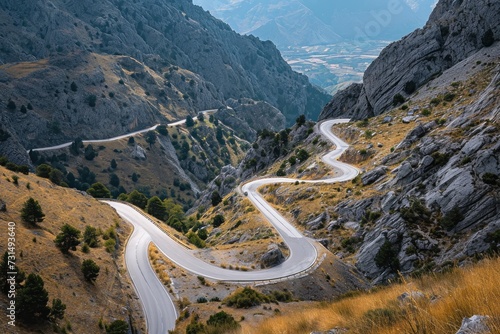 A winding road carves its way through the rugged terrain of a mountain, surrounded by stunning natural scenery, A winding and treacherous mountain road viewed from above, AI Generated