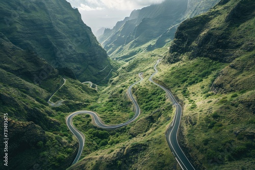 An aerial photograph showcasing the winding curves and twists of a mountain road surrounded by stunning natural scenery, A winding and treacherous mountain road viewed from above, AI Generated