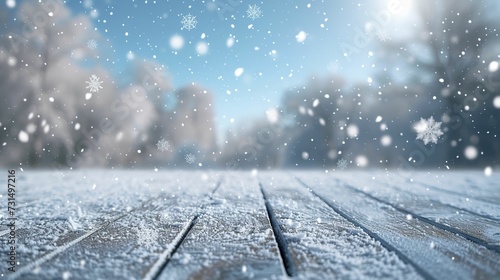 Bokeh background in sky blue and white tones with snowflakes on the floor. 