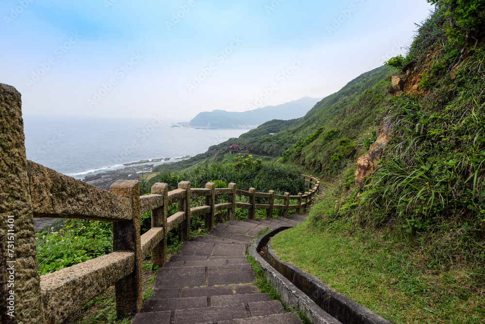 Beautiful rock trails meandered in the mountain, with ocean nearby, in New Taipei City, Taiwan.
