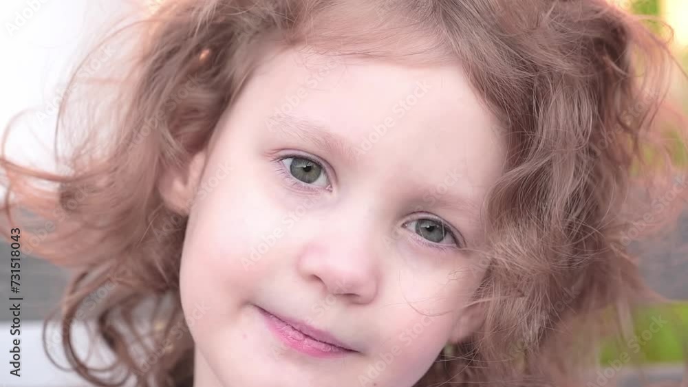 fair-haired curly girl looking into the camera fair-haired curly girl looking into the camera