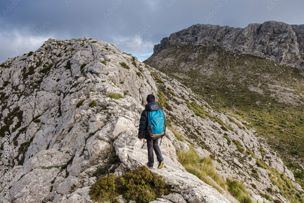 lonely boy on the ridge, ascending to Serra Des Teixos, Escorca, Mallorca, Balearic Islands, Spain