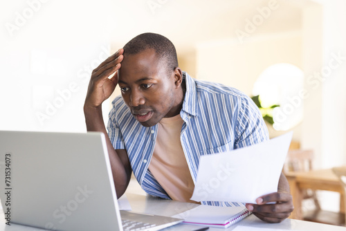Worried African American man at home office photo