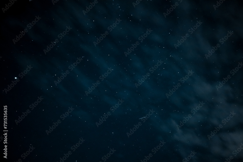 Fototapeta premium Night sky - Universe filled with stars. Stars in the night sky through the clouds