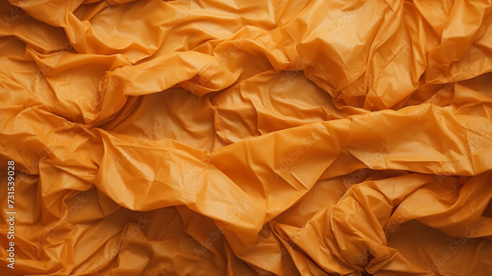 Wrinkled orange paper fragment as a background texture Wrinkled orange paper fragment as a background texture