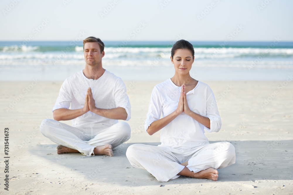 Lotus, yoga and couple on beach in morning for fitness, exercise and mindfulness with prayer hands. Nature, love and man and woman by ocean for meditation, wellness and healthy body outdoors together Lotus, yoga and couple on beach in morning for fitness, exercise and mindfulness with prayer hands. Nature, love and man and woman by ocean for meditation, wellness and healthy body outdoors together