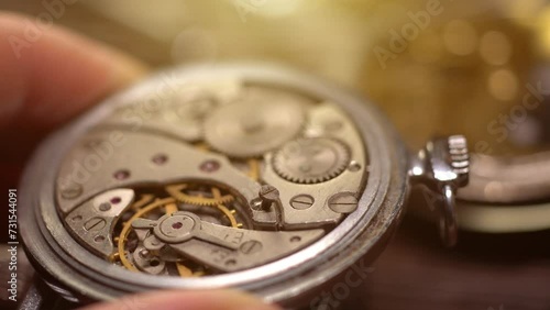 Disassembling mechanical pocket watch. Watchmakers workshop. Vintage watch repair.
