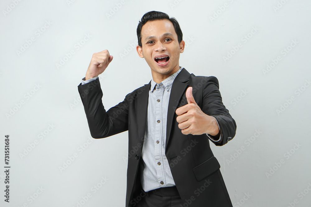 Happy confident asian indonesian business man in suit on isolated background Happy confident asian indonesian business man in suit on isolated background