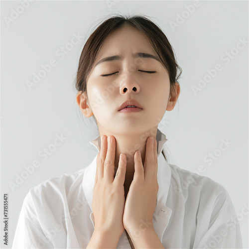 asian woman covering her neck in pain due to thyroid disease  photo