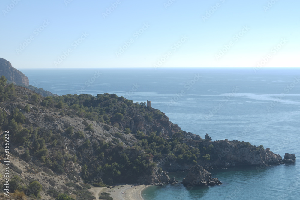Tropical beach with rocks in the Mediterranean sea, Maro, Spain