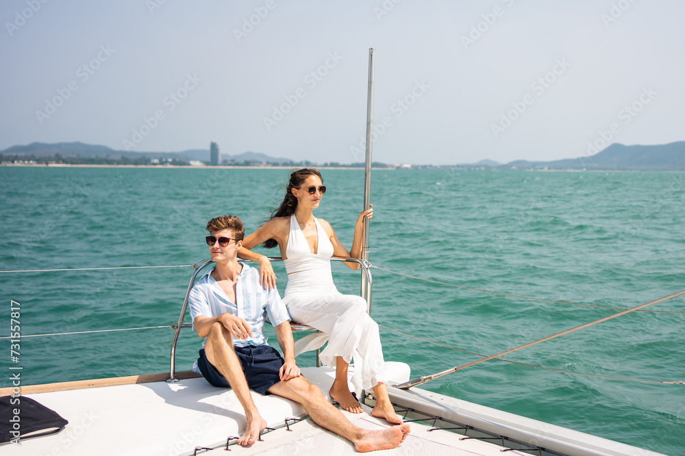Obraz premium Caucasian romantic couple looking at beautiful view during yachting. 