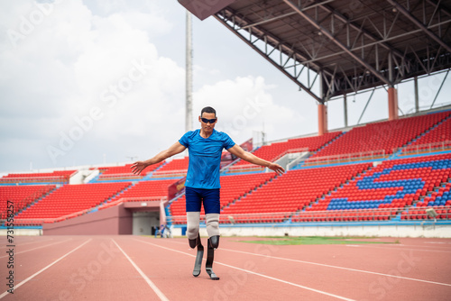 Asian para-athlete with prosthetic blades warms up body in the stadium. 