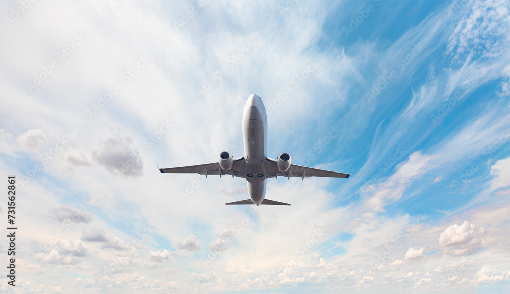 White passenger airplane flying in the sky amazing clouds in the background - Travel by air transport White passenger airplane flying in the sky amazing clouds in the background - Travel by air transport