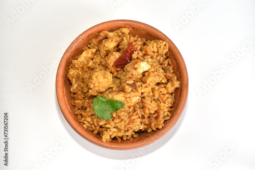Rice with meat, pilaf, in a clay plate on a white background, top view.