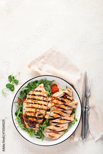 Roasted chicken breast, fillet and fresh vegetable salad.