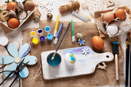 Easter DIY. Easter preparation, multi-colored paints and a brush for decorating eggs. Creativity with children.