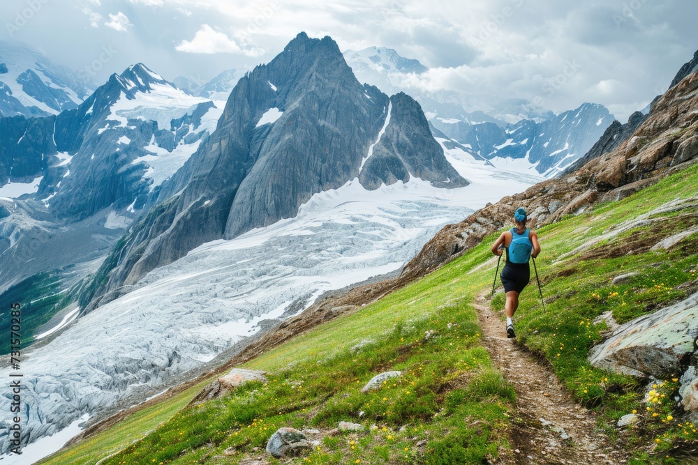 Experienced runner races on mountain trail above glacier.