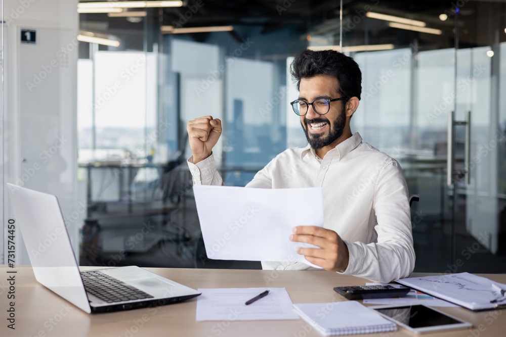 A white-collar worker on a desk with a laptop in an office building. A white-collar worker on a desk with a laptop in an office building.