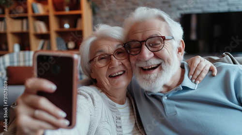 Elderly grandfather and grandmother spend time having fun using smartphone for selfie