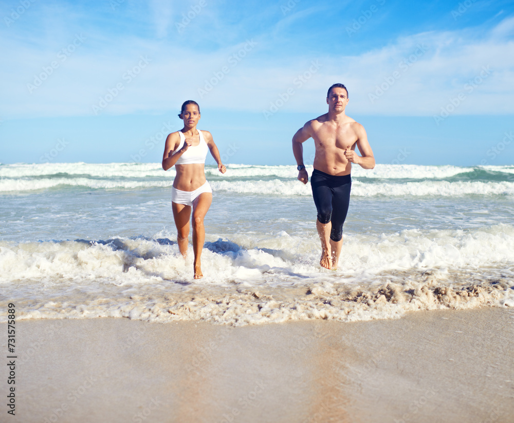 Running, beach and couple with fitness, waves and weekend break with cardio and training for health. Runners, seaside and man with woman and support with practice and activity for wellness and hobby