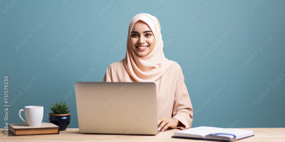 Muslim woman in cream hijab smiling at computer in well-lit workspace. Generative AI Muslim woman in cream hijab smiling at computer in well-lit workspace. Generative AI